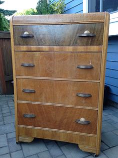 a wooden dresser sitting on top of a brick patio