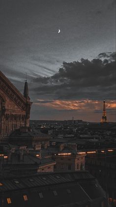 the sky is dark and cloudy, with some buildings lit up in the foreground