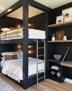 a bedroom with bunk beds and shelves on the wall