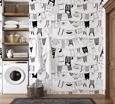 a laundry room with black and white wallpaper