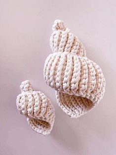 two crocheted shoes are shown on a white surface, one is open and the other is closed