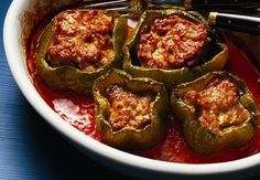 stuffed bell peppers with marinara sauce in a white bowl