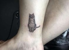 a small cat tattoo on the ankle