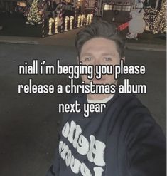 a man is taking a selfie in front of some christmas lights with the caption, nail i'm begging you please release a christmas album next year