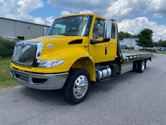 a yellow truck is parked on the street