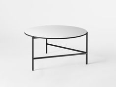 a black and white coffee table with a round top on an isolated surface, viewed from the side