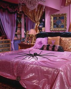 a pink bed with spider decorations on it