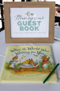 there is a sign that says guest book next to the children's story book