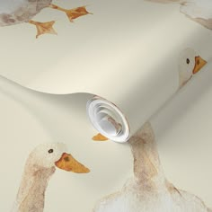 a wallpaper with ducks on it and leaves falling from the top, as well as an empty roll of tape