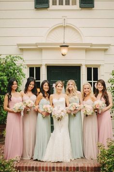 a group of women standing next to each other in front of a building