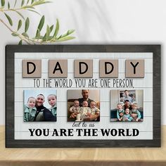 a wooden frame with four photos and the words daddy to the world you are one person