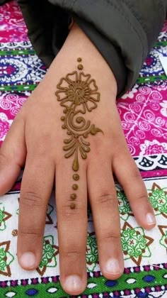 a woman's hand with henna on it