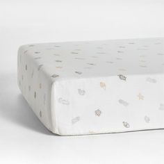 an image of a baby crib sheet with stars and clouds on it in white