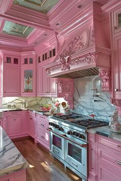 a kitchen with pink cabinets and marble counter tops in an ornately decorated area that looks like a palace