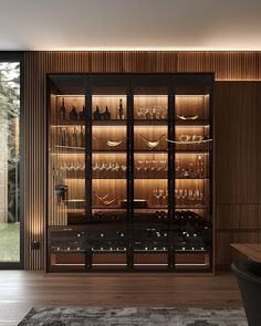 a room with glass doors and shelves filled with wine glasses on the wall next to a rug