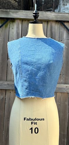 Upcycled vintage denim crop top made from recycled materials handmade in Canada. Raw hemm, neckline and shoulder. Metal hook and eye closure on the back. Cropped Cotton Denim Blue Vest, Cropped Denim Blue Cotton Vest, Cropped Medium Wash Denim Vest, Fitted Cotton Cutoff Top, Stretch Cropped Top In Denim Blue, Stretch Denim Cropped Crop Top, Denim Blue Crop Top, Denim Blue Cropped Cotton Crop Top, Stretch Cropped Denim Blue Top