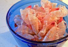 some shrimp in a blue bowl on a table