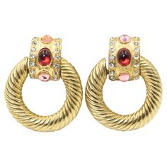 pair of gold tone earrings with red and white stones