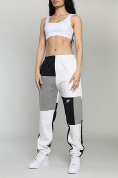 We updated our classic patchwork sweatpants with a straight leg fit for the perfect stack. Upcycled from 3 thrifted sweatshirts. Sourced and reworked in Canada.   DetailsSize: XS, S, MCondition: Good vintage conditionColour: Black, grey, white with embroidered nike logo and swoosh *Model is 5'10, waist 26", hips 38", u Reworked Sweatpants, Colorblock Sweatpants, Reworked Corset, Patchwork Sweatpants, Reworked Sweatshirts, Reworked Nike, Frankie Collective, Nike Vest, Patchwork Hoodie