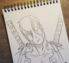 a pencil drawing of a deadpool holding two swords on top of a wooden table