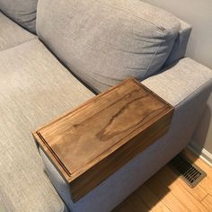 a wooden box sitting on top of a couch