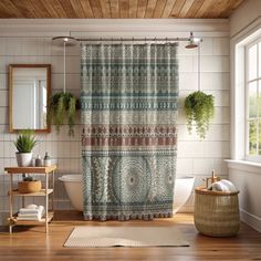 a bath room with a shower curtain and a rug on the floor in front of a window