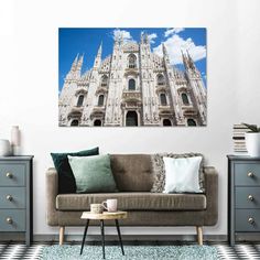 a living room with a couch, coffee table and painting on the wall above it