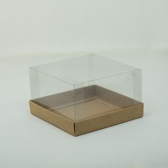 a clear box with a brown lid on a white surface