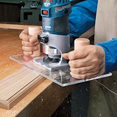 a person using a power tool on a piece of wood