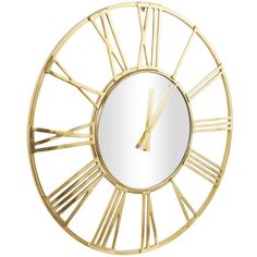 a gold clock with roman numerals and a mirror on the wall in front of it