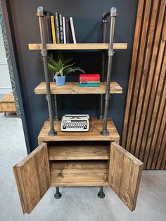 an old typewriter sits in the corner of a room with bookshelves and shelves