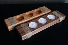 three tea light candles in a wooden holder