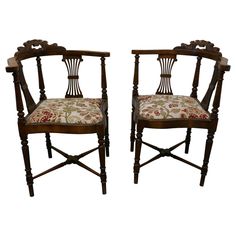 a pair of chairs with floral upholstered seats