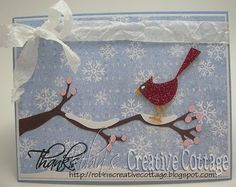 a handmade christmas card with a bird on a branch