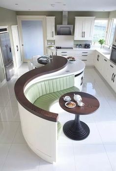 a curved counter in the middle of a kitchen