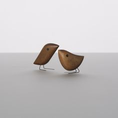 two wooden birds sitting on top of each other