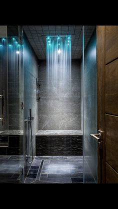 a shower with blue lights on the side