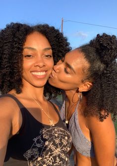 two women are kissing each other on the street