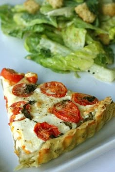 a slice of pizza on a plate next to a salad