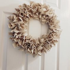 a close up of a door with a wreath hanging on it's front door