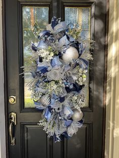 a blue and white wreath on the front door