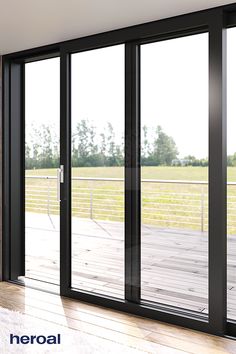 an empty room with sliding glass doors on the outside and wood flooring in the inside