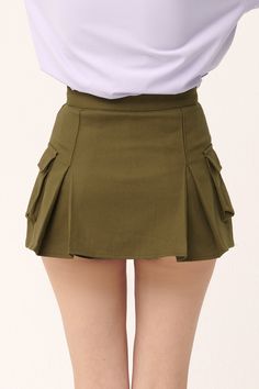 Micro-mini skirt look with lining shorts underneath Faux pocket on the sides Product Specification 97% Cotton 3% Spandex Flat measurement (XS/S) Waist 34cm / hip 43cm / length 35cm (S/M) waist 35.5cm / hip 41cm / length 33cm Professional Clean Only / Do Not Tumble Dry Model's height is 6' 8" (175cm) Bust 31in Waist 23in Hip 34in and wearing XS/S Made in Korea Green Mini Skirt With Built-in Shorts, Cotton Mini Skirt With Built-in Shorts, Stretch Bottoms With Built-in Shorts For School, Fitted Solid Skirt With Pockets, Fitted Mini Cargo Skirt For Summer, Green Mini Tennis Skirt With Built-in Shorts, Stretch Skort With Pockets, Fitted High Waist Shorts With Pockets, Fitted Solid Color Shorts For School