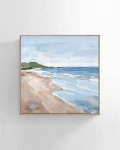 a painting hanging on the wall next to a white wall with a blue ocean and sand beach