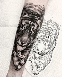 a black and white tiger tattoo on the left arm with another tiger in the background