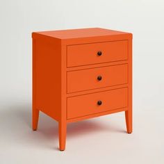 an orange dresser with three drawers on it