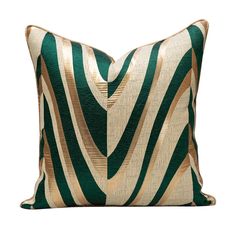 a green and white pillow with gold stripes on the front, sitting on a white surface