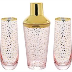 three glass vases with gold lids and dots on the bottom one has a golden lid