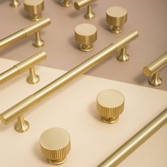 several golden knobs and handles on a white surface