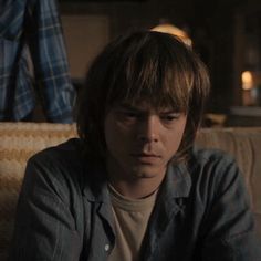 a young man sitting on top of a couch